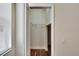 A closet with white trim and wire shelving, providing functional storage space, and hardwood floors extending into the closet at 4634 Mapletree Loop, Wesley Chapel, FL 33544