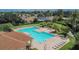 Aerial view of the community pool with ample seating and meticulously kept grounds at 4634 Mapletree Loop, Wesley Chapel, FL 33544