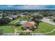 Aerial view of a community pool surrounded by lush landscaping, offering a tranquil and inviting space for residents to relax and enjoy at 4634 Mapletree Loop, Wesley Chapel, FL 33544