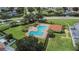Expansive community pool area with numerous lounge chairs and lush green surroundings, perfect for recreation at 4634 Mapletree Loop, Wesley Chapel, FL 33544