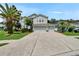 Charming two-story home with a well-manicured lawn, mature landscaping, and a spacious driveway leading to a three-car garage at 4634 Mapletree Loop, Wesley Chapel, FL 33544