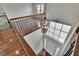 Bright foyer with an ornate chandelier, hardwood floors, and a large window above the entry door at 4634 Mapletree Loop, Wesley Chapel, FL 33544
