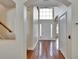 Inviting foyer with hardwood floors, a high ceiling, and a grand front door at 4634 Mapletree Loop, Wesley Chapel, FL 33544