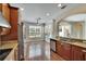Stylish kitchen with stainless steel appliances, granite countertops, and hardwood floors at 4634 Mapletree Loop, Wesley Chapel, FL 33544