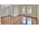 Living room featuring hardwood floors, bright windows, and neutral wall colors at 4634 Mapletree Loop, Wesley Chapel, FL 33544