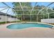 Sparkling screened-in pool with well-kept landscaping at 4634 Mapletree Loop, Wesley Chapel, FL 33544