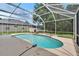 Inviting screened-in pool with clear water and lush landscaping at 4634 Mapletree Loop, Wesley Chapel, FL 33544
