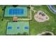 Overhead view of community amenities, including a tennis court, basketball court, and playground area at 4634 Mapletree Loop, Wesley Chapel, FL 33544
