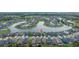 An aerial view captures a community with waterfront properties and well-maintained landscaping at 4644 San Martino Dr, Wesley Chapel, FL 33543