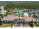 Aerial view showing the community pool, lush landscaping, and community center at 4644 San Martino Dr, Wesley Chapel, FL 33543