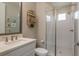 Bright bathroom featuring a glass-enclosed shower, white vanity and modern fixtures at 4644 San Martino Dr, Wesley Chapel, FL 33543