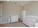 Cozy Bedroom with a white crib, dresser, and wardrobe at 4644 San Martino Dr, Wesley Chapel, FL 33543