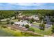 Aerial view of clubhouse, pool with slide, and lake in a lush community at 4644 San Martino Dr, Wesley Chapel, FL 33543