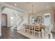 Spacious dining room with view of entry hall featuring staircase and entry to living spaces and adjacent view to the dining buffet at 4644 San Martino Dr, Wesley Chapel, FL 33543