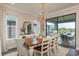 Bright dining room boasts a chandelier, a buffet with mirror, and access to the covered patio with views of the lake at 4644 San Martino Dr, Wesley Chapel, FL 33543