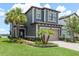 Charming two-story home featuring a two-car garage, lush landscaping, and elegant architectural details at 4644 San Martino Dr, Wesley Chapel, FL 33543