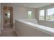 Upstairs hallway with multiple windows offering plenty of natural light at 4644 San Martino Dr, Wesley Chapel, FL 33543
