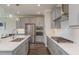 A kitchen is designed with stainless steel appliances, a gas cooktop, white subway tile, and ample storage space at 4644 San Martino Dr, Wesley Chapel, FL 33543