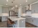 Modern kitchen with stainless steel appliances, quartz countertops, and pendant lighting over the island at 4644 San Martino Dr, Wesley Chapel, FL 33543