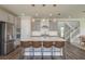 Well-equipped kitchen boasts a central island with bar stools, stainless steel appliances, and contemporary pendant lighting at 4644 San Martino Dr, Wesley Chapel, FL 33543