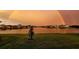 Scenic view of the lake community with a beautiful rainbow spanning across the horizon at 4644 San Martino Dr, Wesley Chapel, FL 33543