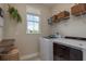 This laundry room features a window, a folding table, front-load machines, and plenty of storage space at 4644 San Martino Dr, Wesley Chapel, FL 33543