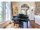 Living room featuring a grand piano, bright window views, hardwood flooring, and elegant neutral decor at 4644 San Martino Dr, Wesley Chapel, FL 33543