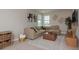 Cozy living room featuring a sectional sofa, neutral color palette, and natural light at 4644 San Martino Dr, Wesley Chapel, FL 33543