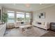 Cozy living room with comfortable seating, large windows offering serene water views and stylish decor at 4644 San Martino Dr, Wesley Chapel, FL 33543