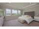 Spacious main bedroom with tray ceiling, plush carpet and water view at 4644 San Martino Dr, Wesley Chapel, FL 33543