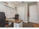 Stylish home office featuring a wood desk, shelving, and modern decor at 4644 San Martino Dr, Wesley Chapel, FL 33543