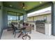 This outdoor kitchen has a grill, counter space, and dining area at 4644 San Martino Dr, Wesley Chapel, FL 33543
