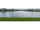 Lake view property featuring a tranquil pond surrounded by homes in a well-manicured community at 4644 San Martino Dr, Wesley Chapel, FL 33543
