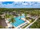 Resort-style pool area with lap lanes, lounge chairs, palm trees, and water slide at 4644 San Martino Dr, Wesley Chapel, FL 33543