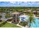 Resort-style pool with slide, seating and landscaping, surrounded by lush greenery and trees at 4644 San Martino Dr, Wesley Chapel, FL 33543