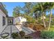 A backyard featuring a hot tub, patio, and lush greenery at 4708 W Neptune St, Tampa, FL 33629