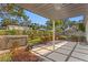 Backyard featuring a hot tub, patio and tropical greenery at 4708 W Neptune St, Tampa, FL 33629
