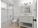 Updated bathroom features a shower over tub, a modern vanity, and bright lighting at 4708 W Neptune St, Tampa, FL 33629