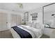 Bedroom with mirrors, neutral decor and plenty of natural light at 4708 W Neptune St, Tampa, FL 33629