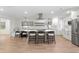 Modern kitchen with white cabinets, island with seating, stainless appliances, and eat in dining at 4708 W Neptune St, Tampa, FL 33629