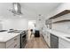 Bright kitchen with white marble counter tops, stainless appliances, and seating area at 4708 W Neptune St, Tampa, FL 33629