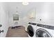 Laundry room features a modern washer and dryer, and natural light at 4708 W Neptune St, Tampa, FL 33629