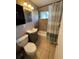 This bathroom has neutral tile, shower, vanity, toilet, and a black medicine cabinet at 4721 W Wallace Ave, Tampa, FL 33611