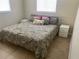 This primary bedroom has beautiful tile flooring and modern white nightstands at 4721 W Wallace Ave, Tampa, FL 33611