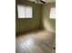 This bedroom features tile floor, two windows, and ceiling fan at 4721 W Wallace Ave, Tampa, FL 33611