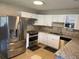 Spacious kitchen with stainless steel appliances, granite countertops, and white cabinets at 4721 W Wallace Ave, Tampa, FL 33611