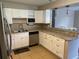 Updated kitchen with stainless steel appliances and white cabinets at 4721 W Wallace Ave, Tampa, FL 33611