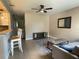 Bright living room with tiled flooring, a ceiling fan, and view into the kitchen at 4721 W Wallace Ave, Tampa, FL 33611