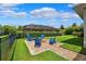 Beautiful backyard with seating area and a view of the home's screened porch with a view of the sky at 6007 Quartz Lake Way, Lithia, FL 33547