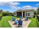 Beautiful backyard with seating area and a view of the home's screened porch with a view of the sky at 6007 Quartz Lake Way, Lithia, FL 33547